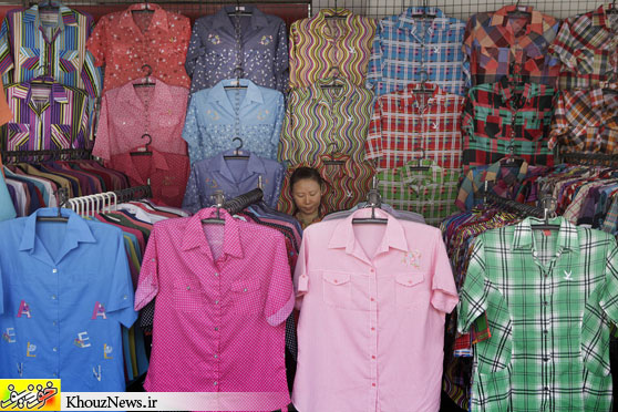 BUTTON DOWNS: A vendor waited for customers in Bangkok on Thursday. (Xinyan Yu/Associated Press)