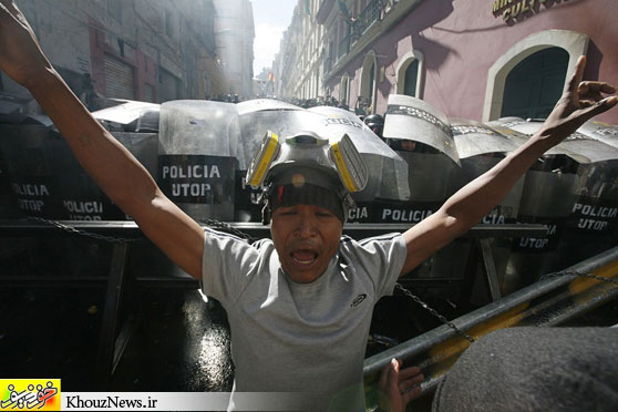 PARK PROTEST: An Amazonian indigenous man protested in front of riot policemen during clashes in La Paz, Bolivia, Thursday. Indigenous people from the territory of the of national park Isiboro Secure are protesting the planned construction of a highway through the park. (Gaston Brito/Reuters)